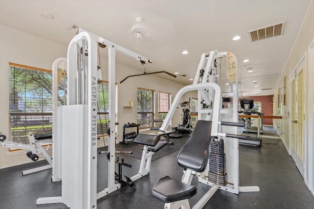 workout area with recessed lighting, baseboards, visible vents, and plenty of natural light