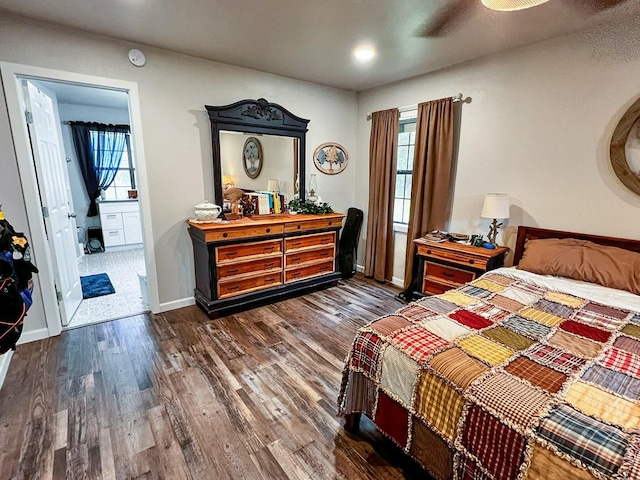 bedroom featuring connected bathroom, recessed lighting, baseboards, and wood finished floors