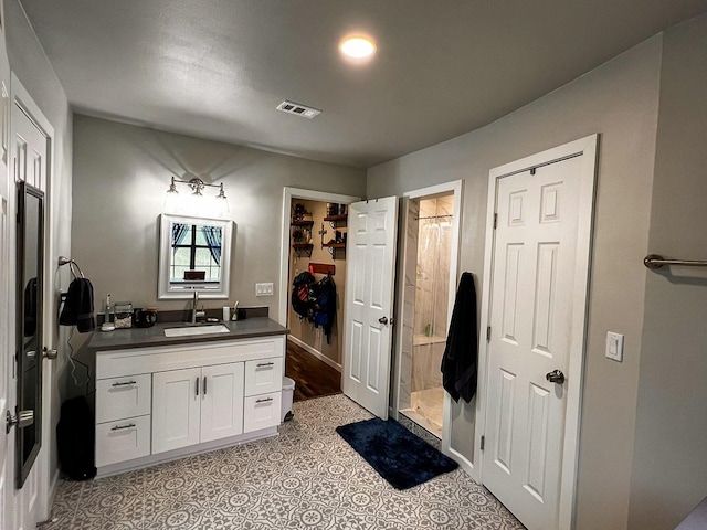 full bathroom with vanity, visible vents, baseboards, tile patterned floors, and a shower stall