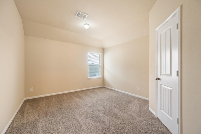 spare room with baseboards, carpet flooring, and visible vents