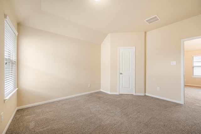 unfurnished room featuring baseboards, carpet, and visible vents