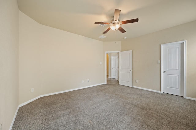 unfurnished room featuring carpet floors, ceiling fan, visible vents, and baseboards