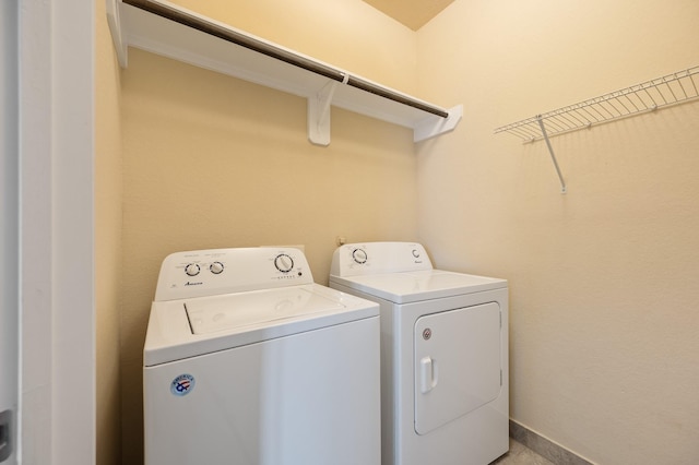 clothes washing area with independent washer and dryer and laundry area