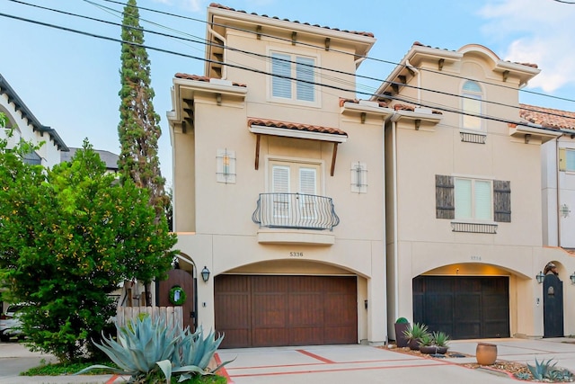 5336 Inker St, Houston, TX 77007 - mediterranean / spanish house with driveway, a tile roof, a garage, a balcony, and stucco siding