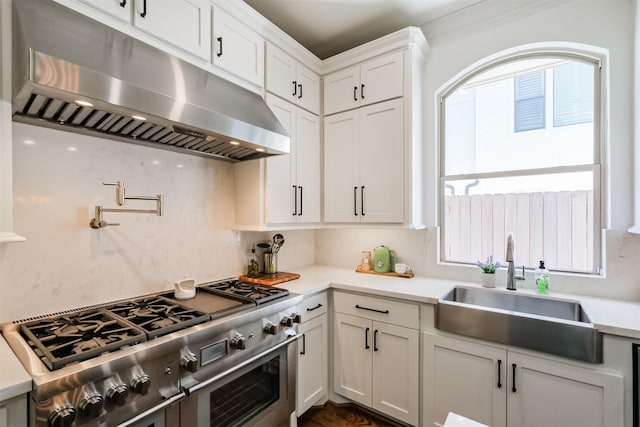 5336 Inker St, Houston, TX 77007 - kitchen featuring double oven range, a sink, light countertops, white cabinets, and under cabinet range hood