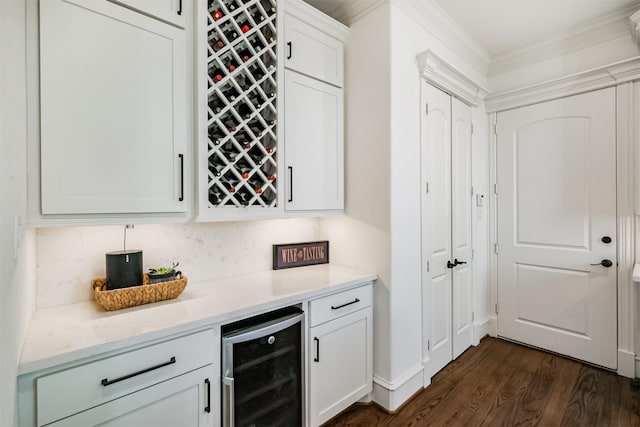 5336 Inker St, Houston, TX 77007 - bar with a dry bar, ornamental molding, beverage cooler, and dark wood-type flooring