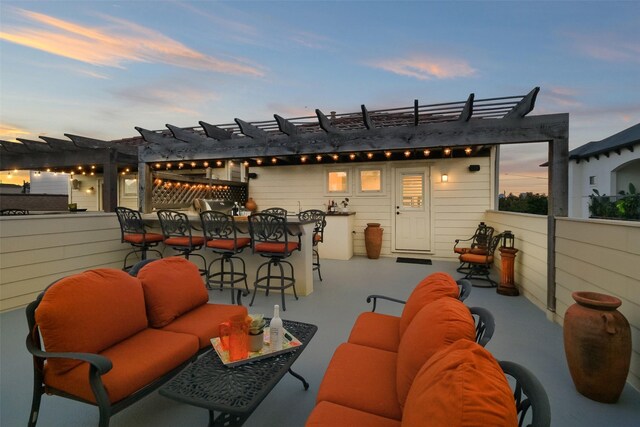 5336 Inker St, Houston, TX 77007 - patio terrace at dusk with an outdoor hangout area, outdoor dry bar, and a pergola