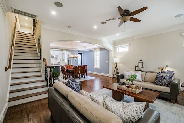 5336 Inker St, Houston, TX 77007 - living room featuring visible vents, crown molding, stairs, wood finished floors, and arched walkways