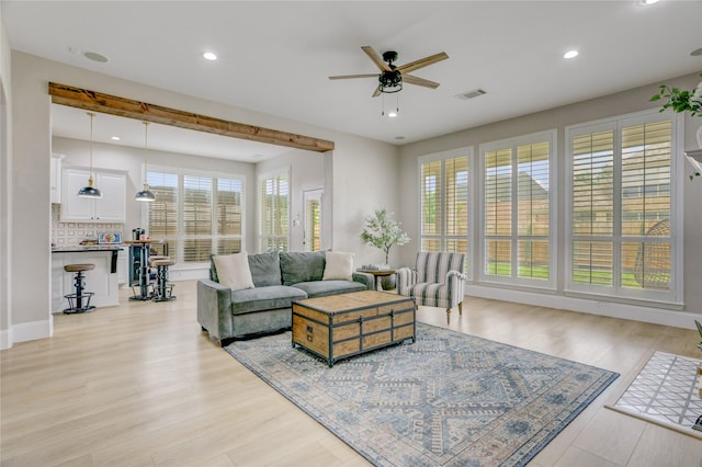 living room featuring visible vents, a ceiling fan, light wood-style flooring, and recessed lighting