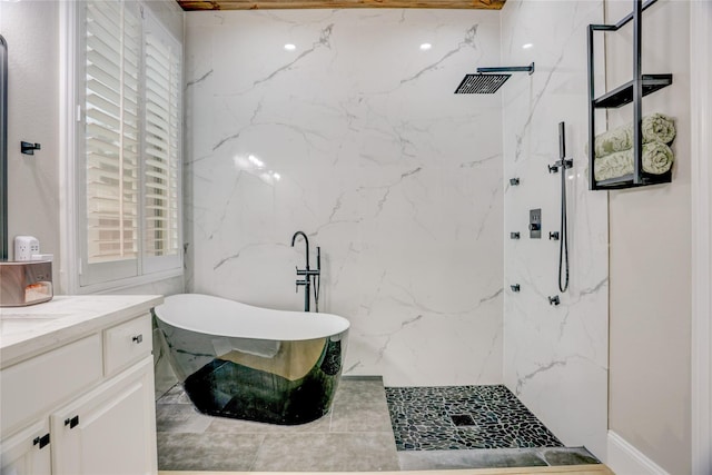 bathroom with vanity, a marble finish shower, and a freestanding bath