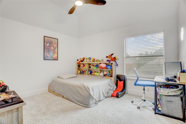 carpeted bedroom with baseboards, a ceiling fan, and vaulted ceiling