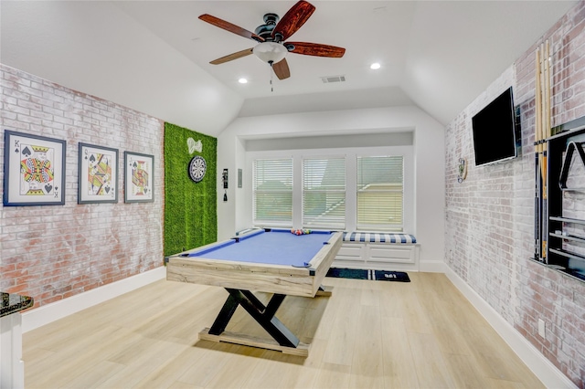 playroom featuring visible vents, baseboards, wood finished floors, and brick wall