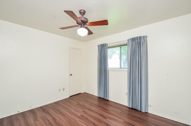empty room featuring baseboards, ceiling fan, and wood finished floors