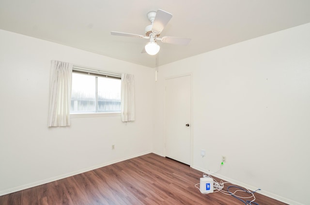 unfurnished room featuring a ceiling fan, baseboards, and wood finished floors