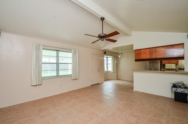 unfurnished living room with a ceiling fan, lofted ceiling with beams, and light tile patterned flooring