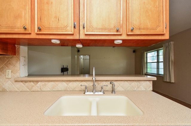 kitchen with a sink and backsplash