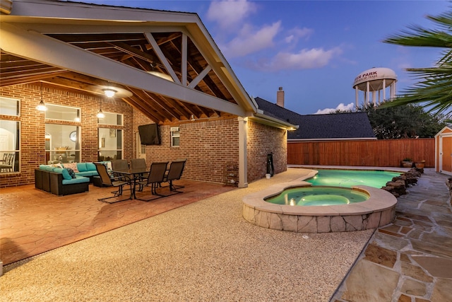 view of swimming pool featuring a storage shed, outdoor dining area, an in ground hot tub, a patio area, and an outdoor structure