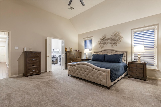 carpeted bedroom with high vaulted ceiling, baseboards, ceiling fan, and visible vents
