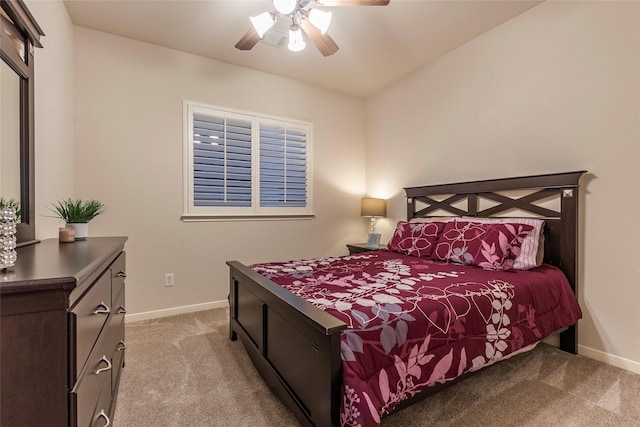 bedroom featuring baseboards, a ceiling fan, and light colored carpet