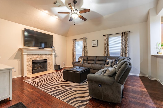 living room featuring a ceiling fan, visible vents, a fireplace, wood finished floors, and baseboards