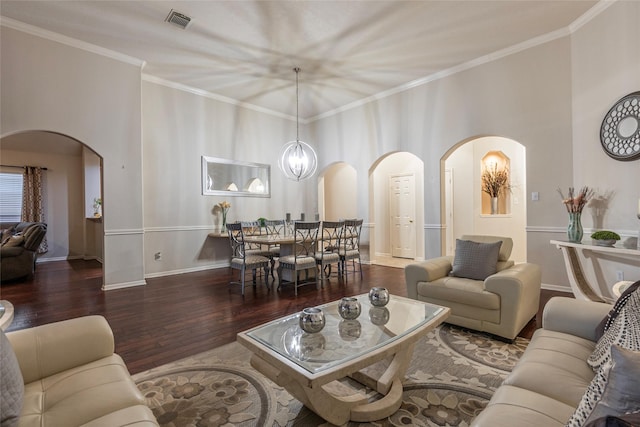 living room featuring visible vents, crown molding, wood finished floors, baseboards, and arched walkways