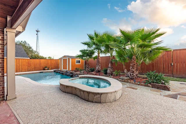 view of pool with a fenced in pool, an outbuilding, a shed, and a fenced backyard