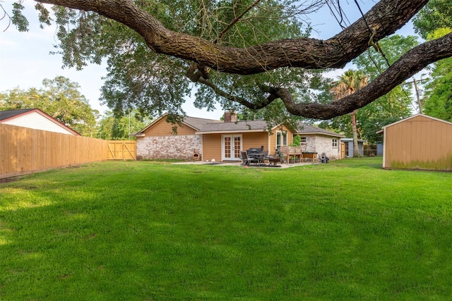 back of house with a lawn, french doors, fence private yard, and a chimney