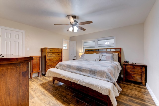 bedroom featuring baseboards, ceiling fan, and wood finished floors