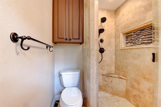 bathroom with a stall shower and toilet