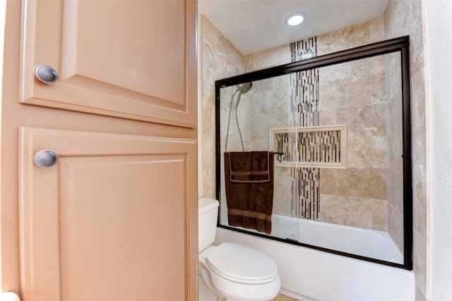 full bath featuring bath / shower combo with glass door and toilet