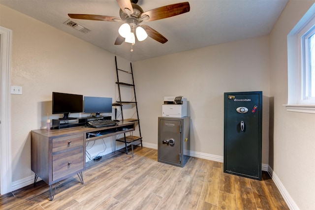 office area featuring visible vents, a ceiling fan, baseboards, and wood finished floors