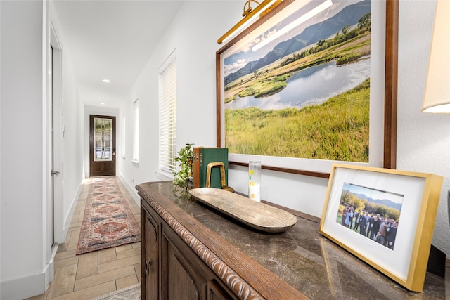 hallway featuring recessed lighting and baseboards