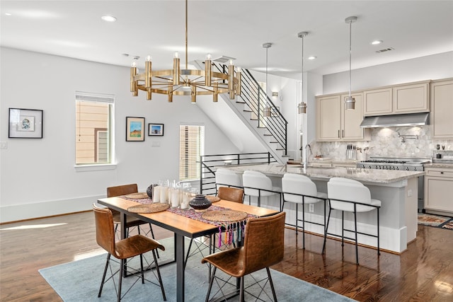 dining area with an inviting chandelier, stairs, recessed lighting, visible vents, and dark wood-style floors