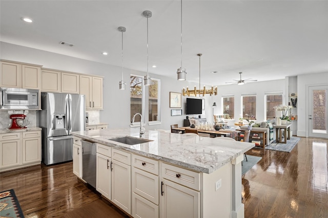 kitchen with dark wood-style flooring, visible vents, appliances with stainless steel finishes, a sink, and open floor plan