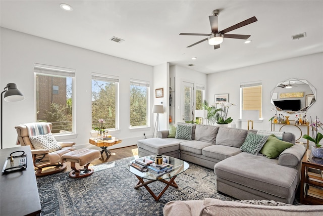 living area with ceiling fan, recessed lighting, wood finished floors, and visible vents