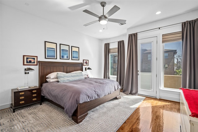 bedroom with a ceiling fan, recessed lighting, wood finished floors, and access to exterior