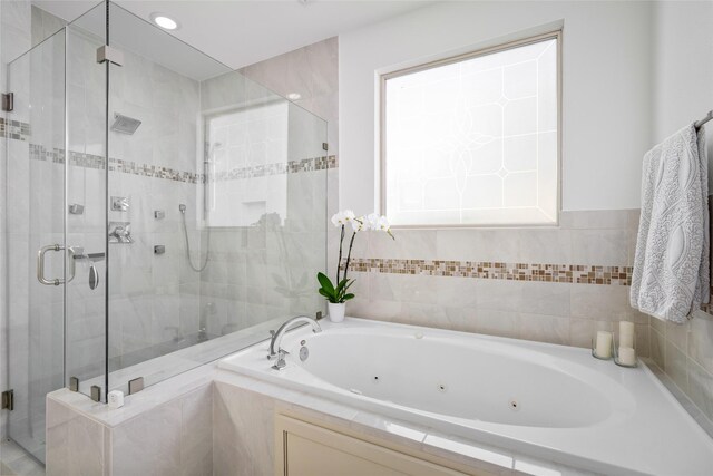 full bath with a whirlpool tub and a shower stall