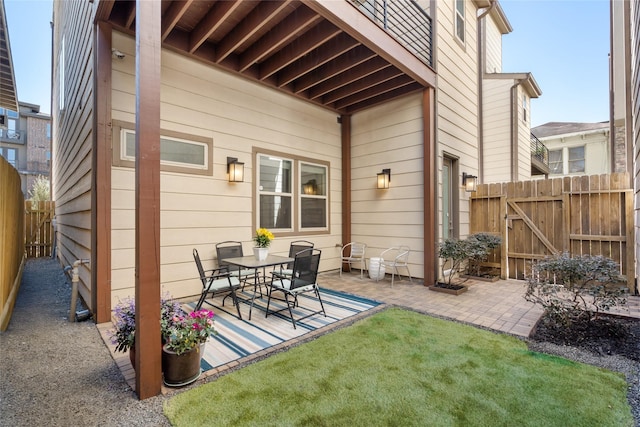 view of patio featuring a gate and fence