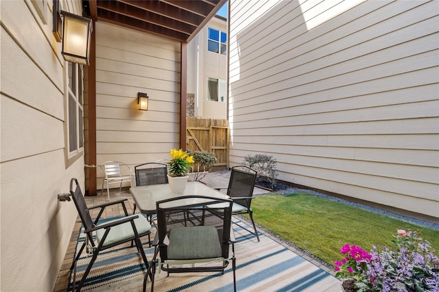 view of patio / terrace featuring fence and outdoor dining space