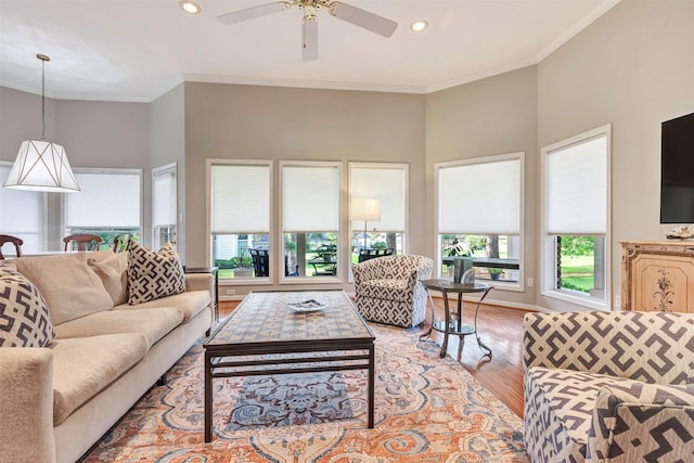 living area with recessed lighting, ornamental molding, light wood finished floors, and ceiling fan