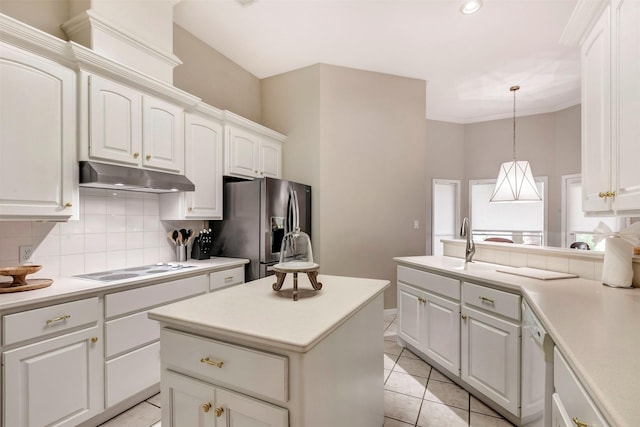 kitchen featuring a sink, white appliances, white cabinetry, tasteful backsplash, and under cabinet range hood