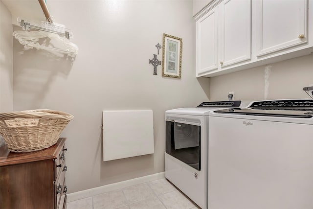 washroom featuring light tile patterned floors, baseboards, independent washer and dryer, and cabinet space