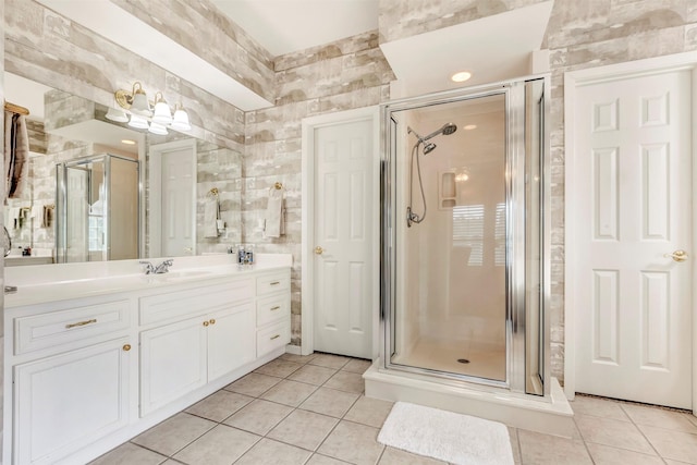 full bathroom featuring vanity, tile patterned flooring, and a shower stall