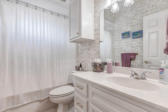 full bath with vanity, tile patterned floors, toilet, and shower / tub combo