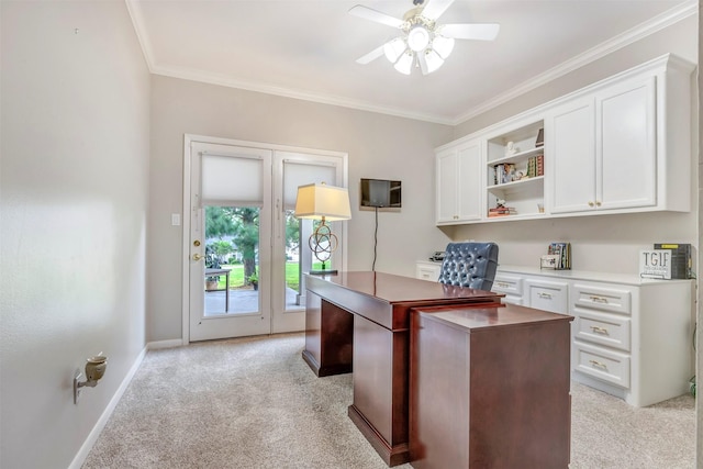 office space with crown molding, ceiling fan, light carpet, and baseboards