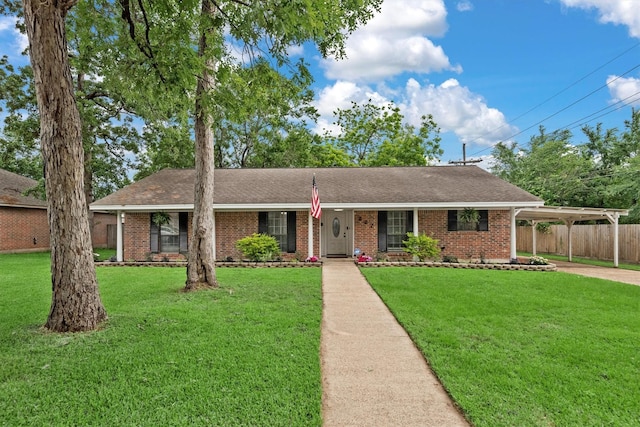 227 Oak Hollow St, Conroe, TX 77301 - ranch-style house with fence, brick siding, an attached carport, a front yard, and concrete driveway