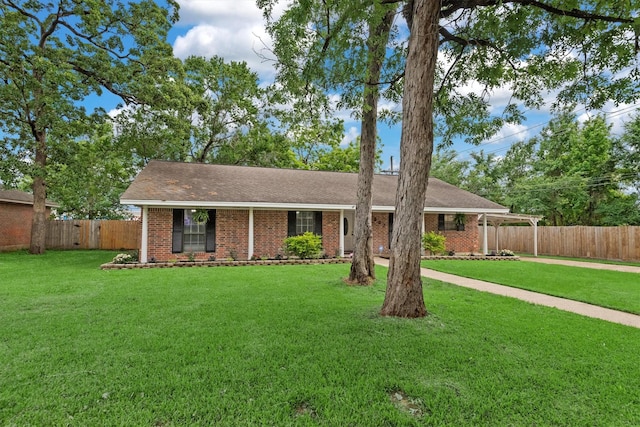227 Oak Hollow St, Conroe, TX 77301 - single story home with fence, a front lawn, and brick siding