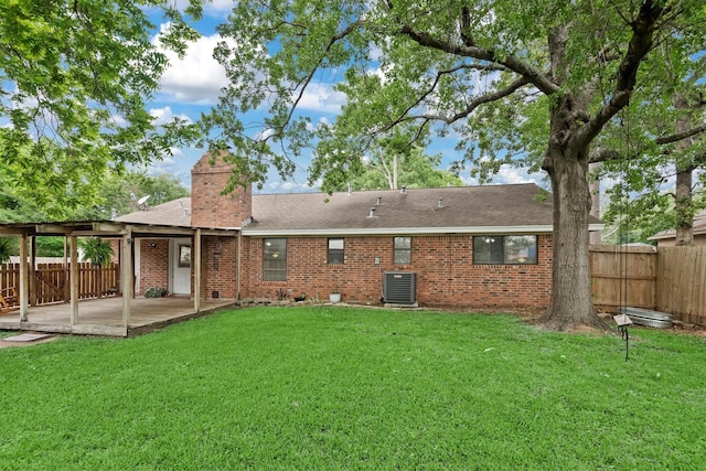 227 Oak Hollow St, Conroe, TX 77301 - rear view of house featuring a lawn, a patio, a fenced backyard, and central AC