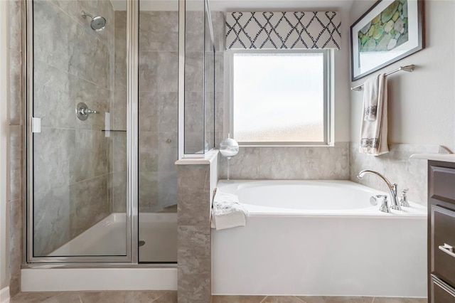 bathroom with vanity, a garden tub, and a stall shower