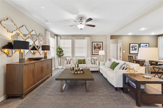living room featuring baseboards, a ceiling fan, recessed lighting, and visible vents